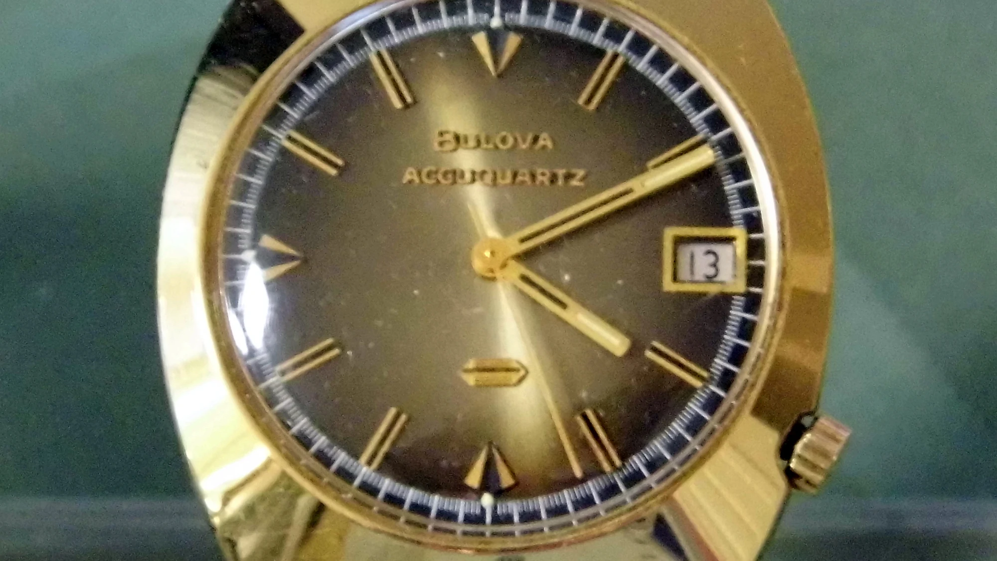 Vintage watch with gold electroplated bezel highlighting plated construction